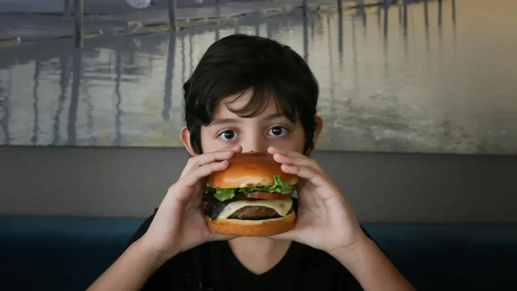 Boy holding a burger