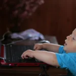 Baby looking at laptop