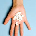 Hand holding pills