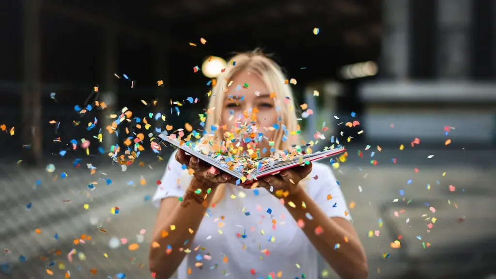 Woman blowing confetti