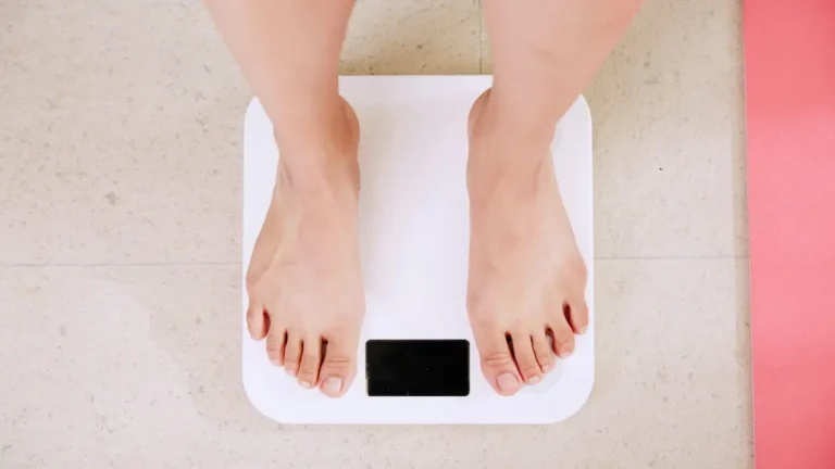 Woman's feet standing on a scale