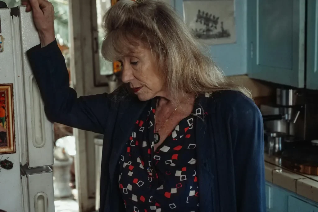Elderly woman in front of fridge